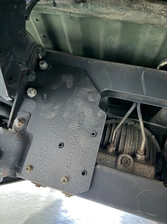 Close-up custom black textured mounting plate bolted to frame rails with pre-drilled horn holes Outlaw Train Horn install on Greg's 2008 AM General HMMWV Humvee gallery photo 3