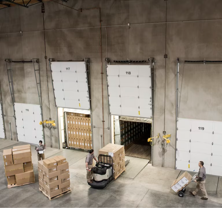 warheouse workers unloading a truck of return items
