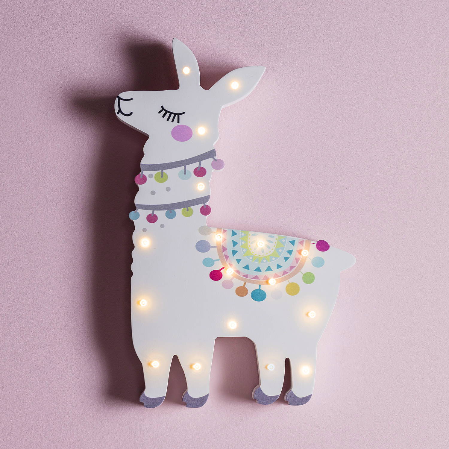 Llama wall light illuminated on pink wall