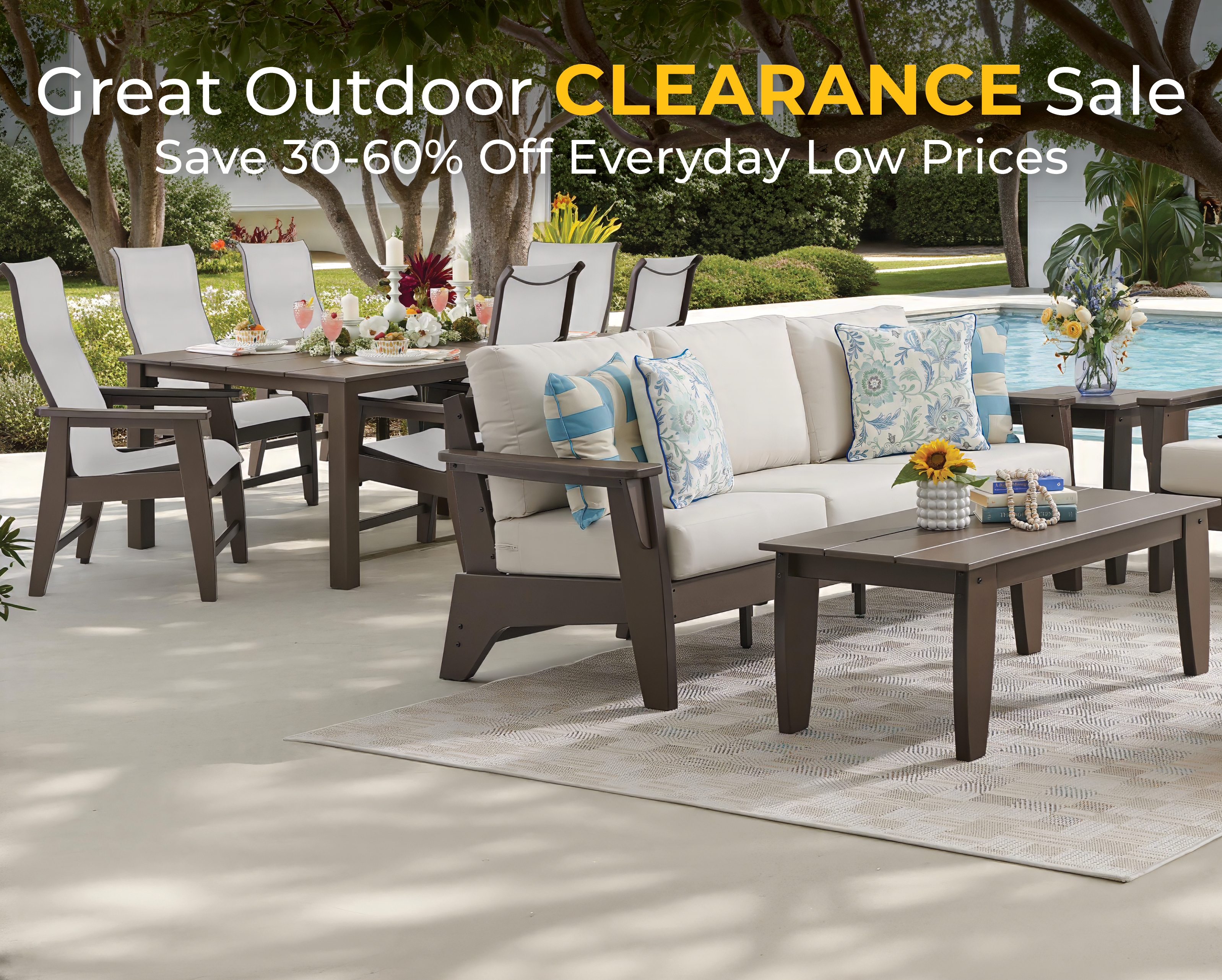 Outdoor furniture sale with seating and a table by a pool.