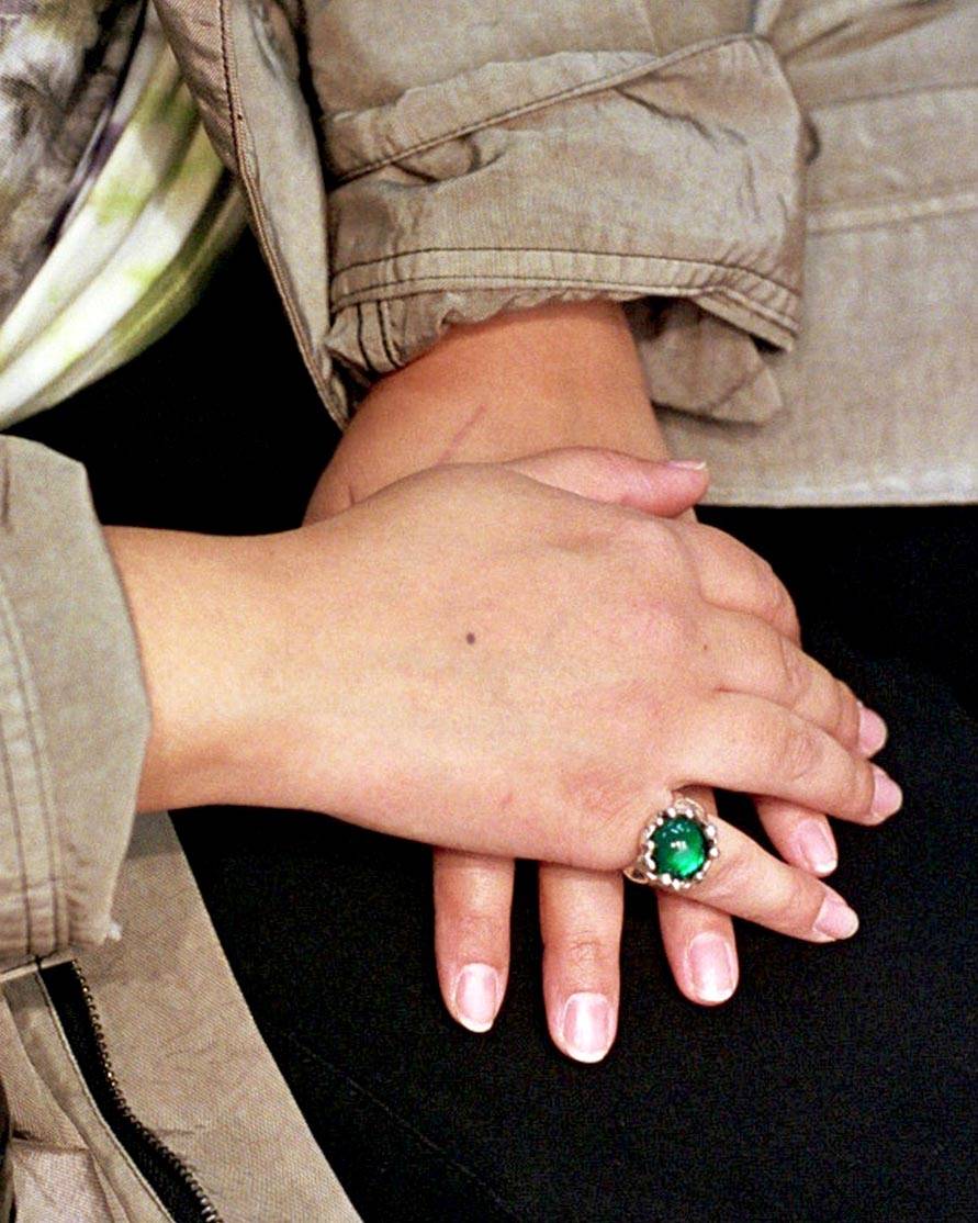Close up of Sara's hands wearing a green Mondo Mondo ring. 