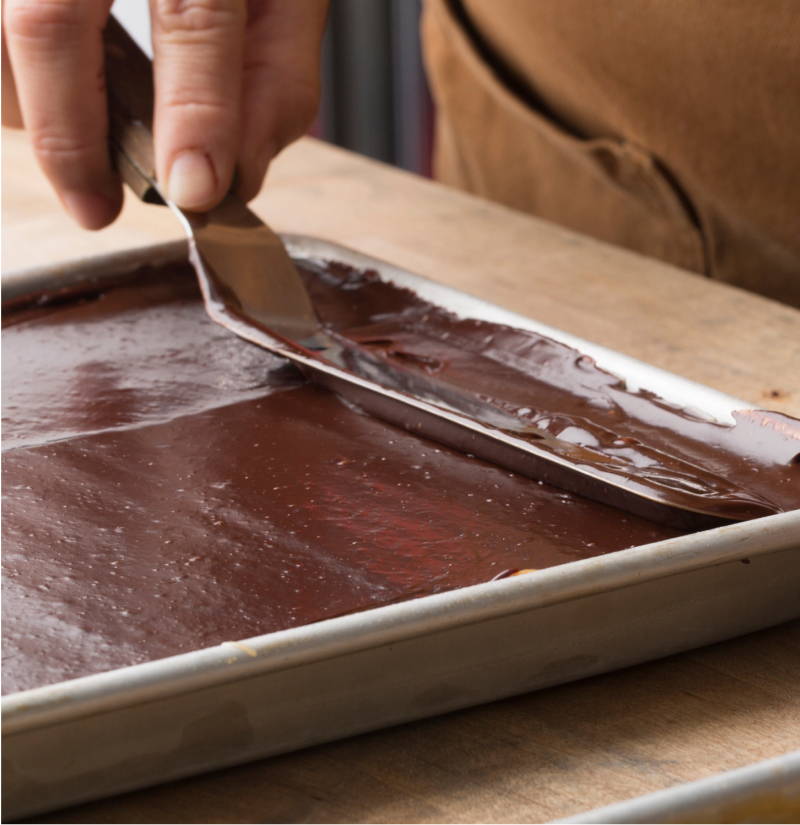 Chocolate being smoothed onto sheet