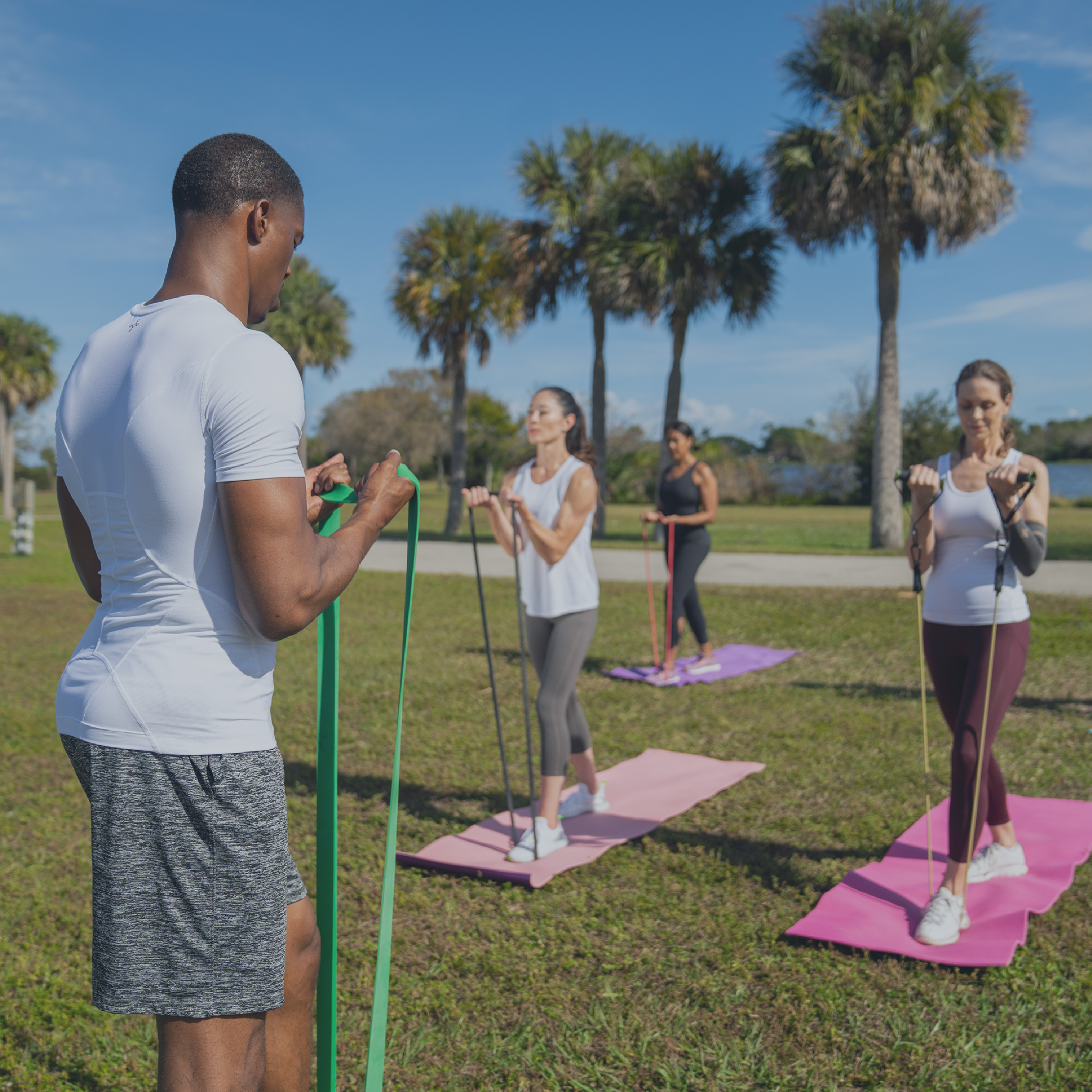 Group exercising outdoors using Tommie Copper products