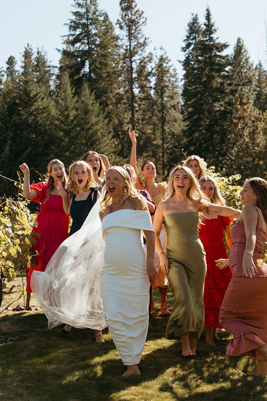 A group of women celebrating outdoors in colorful dresses.