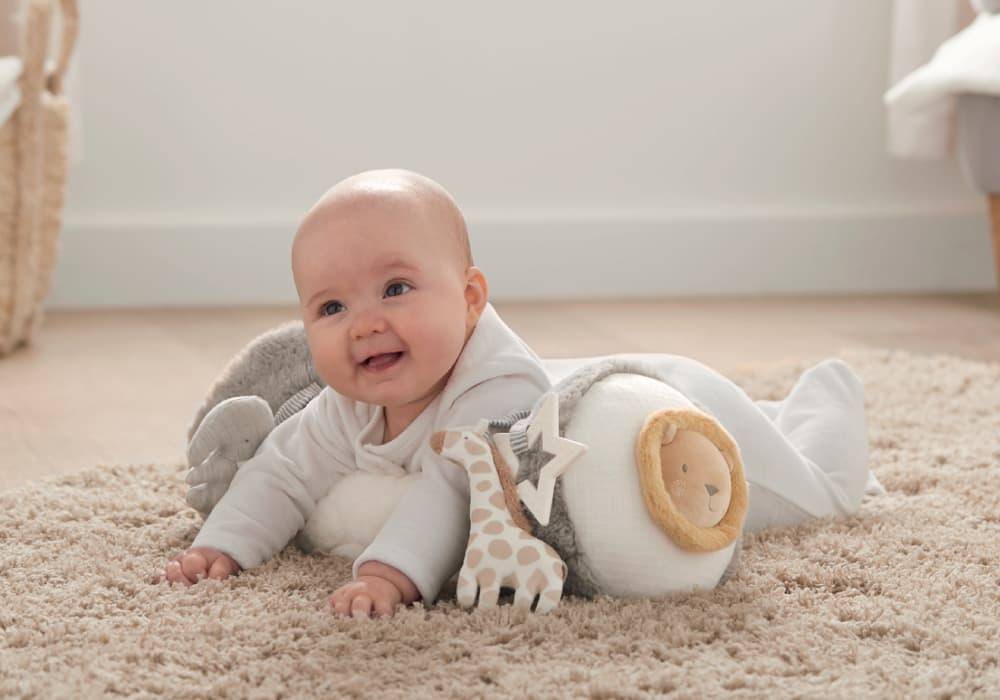 Baby laid on a tummy time soft toy