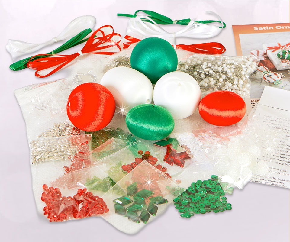 Craft supplies including colored balls, decorative items, and ribbons.