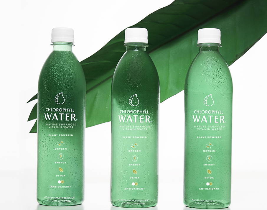 three bottles of chlorophyll water in front of leaf
