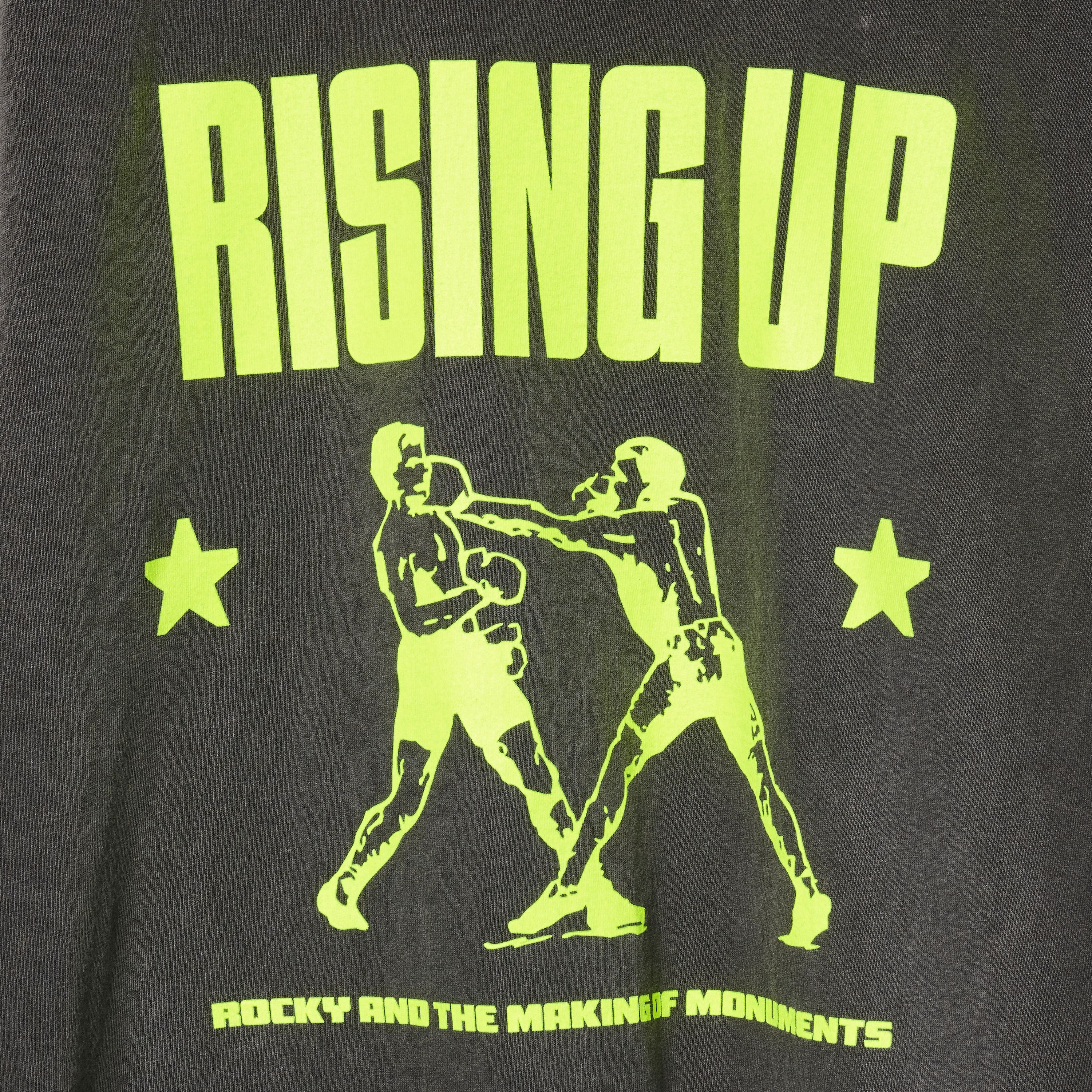 Close up of a graphic of two boxers with neon-yellow text 