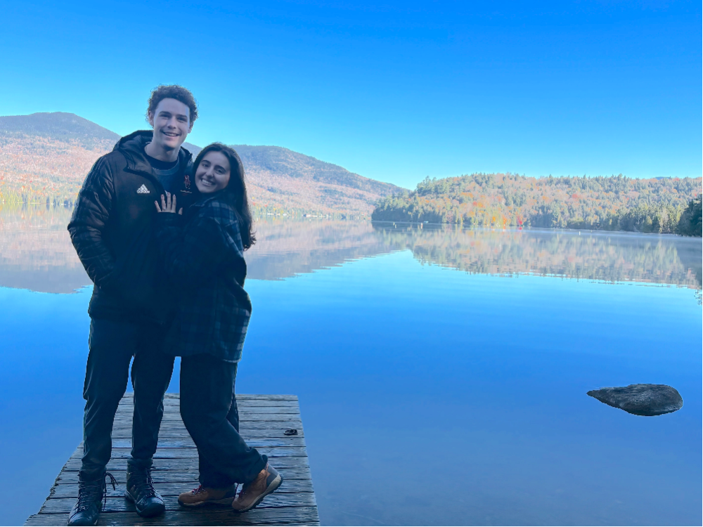 couple standing next to lake placid, ny