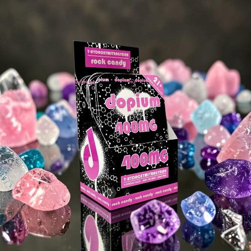 Black and pink packaging surrounded by colorful gemstones.