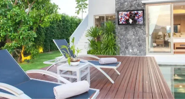 The TV Shield outdoors in front of a pool and patio area