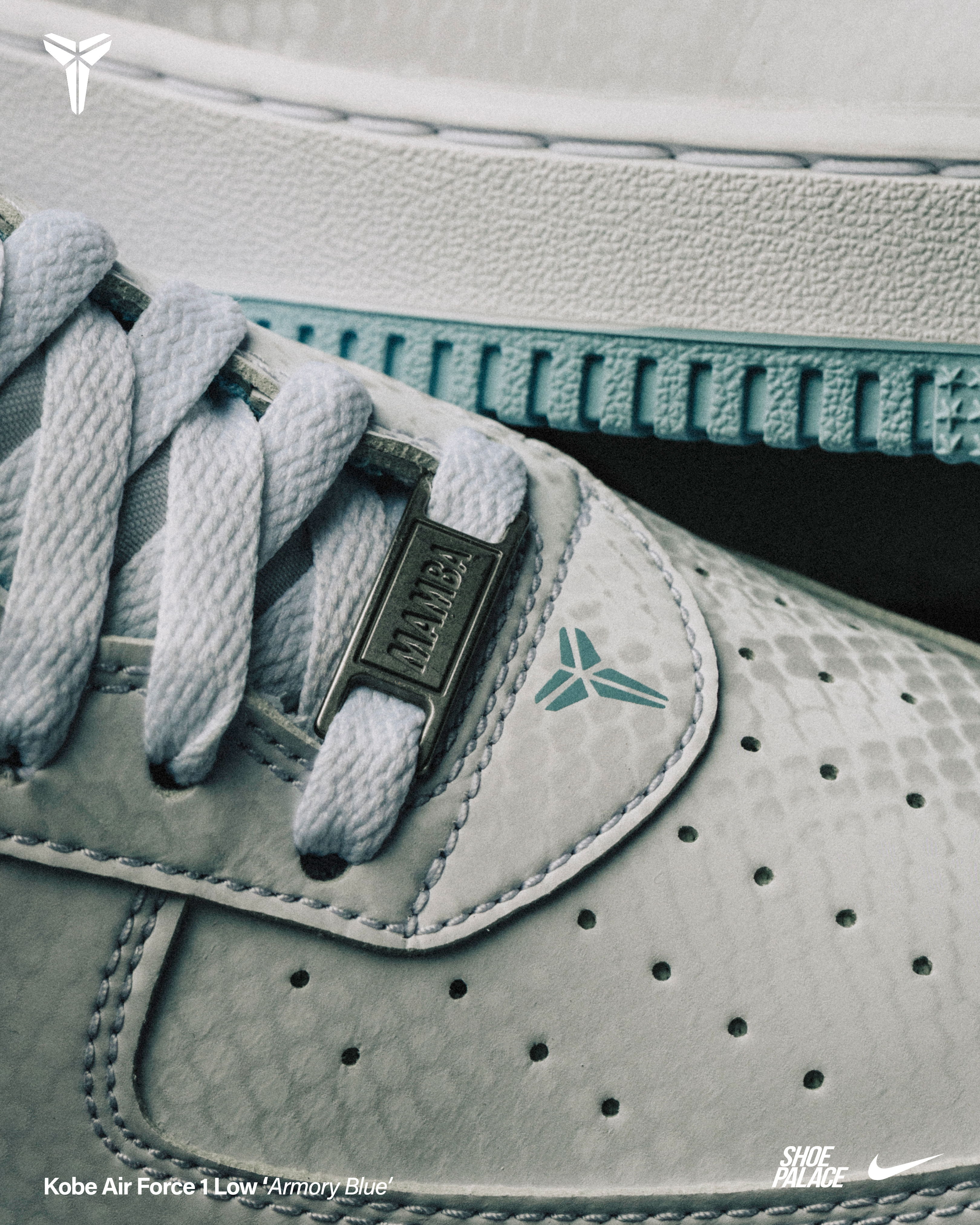 Close-up of Kobe Air Flight sneakers with gray and blue accents.