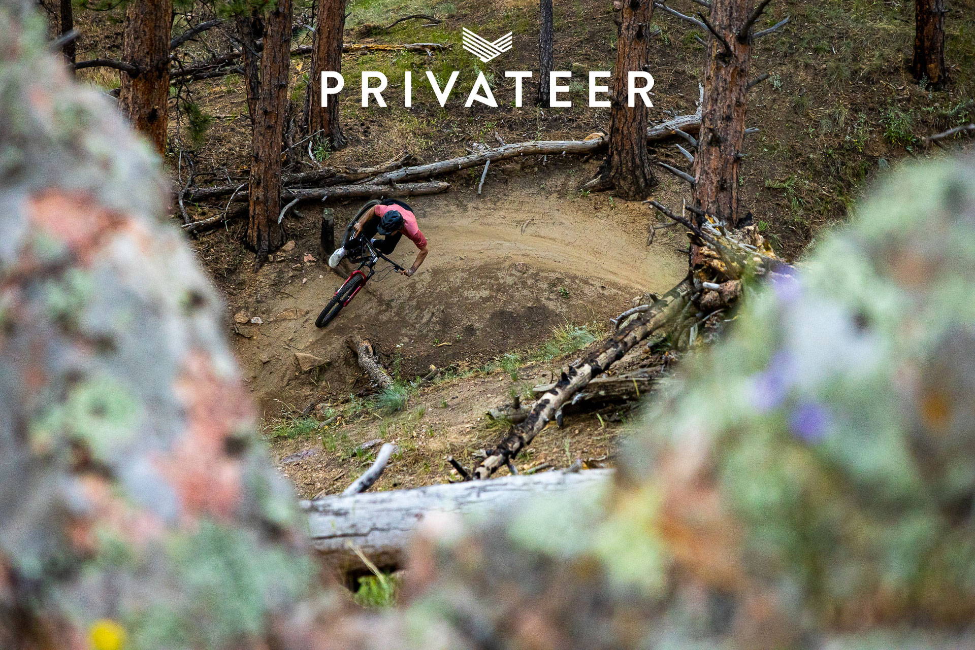 Dom Knight riding a berm with a Privateer Bikes logo