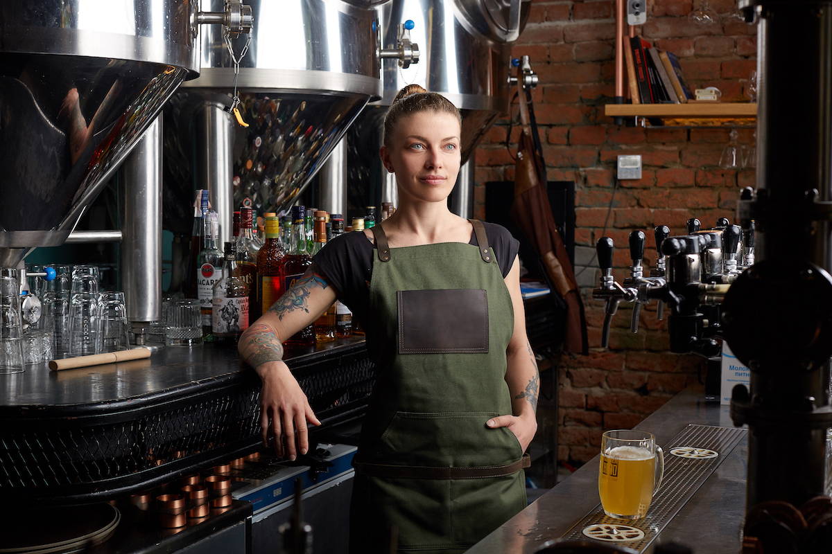 female bartender in green apron