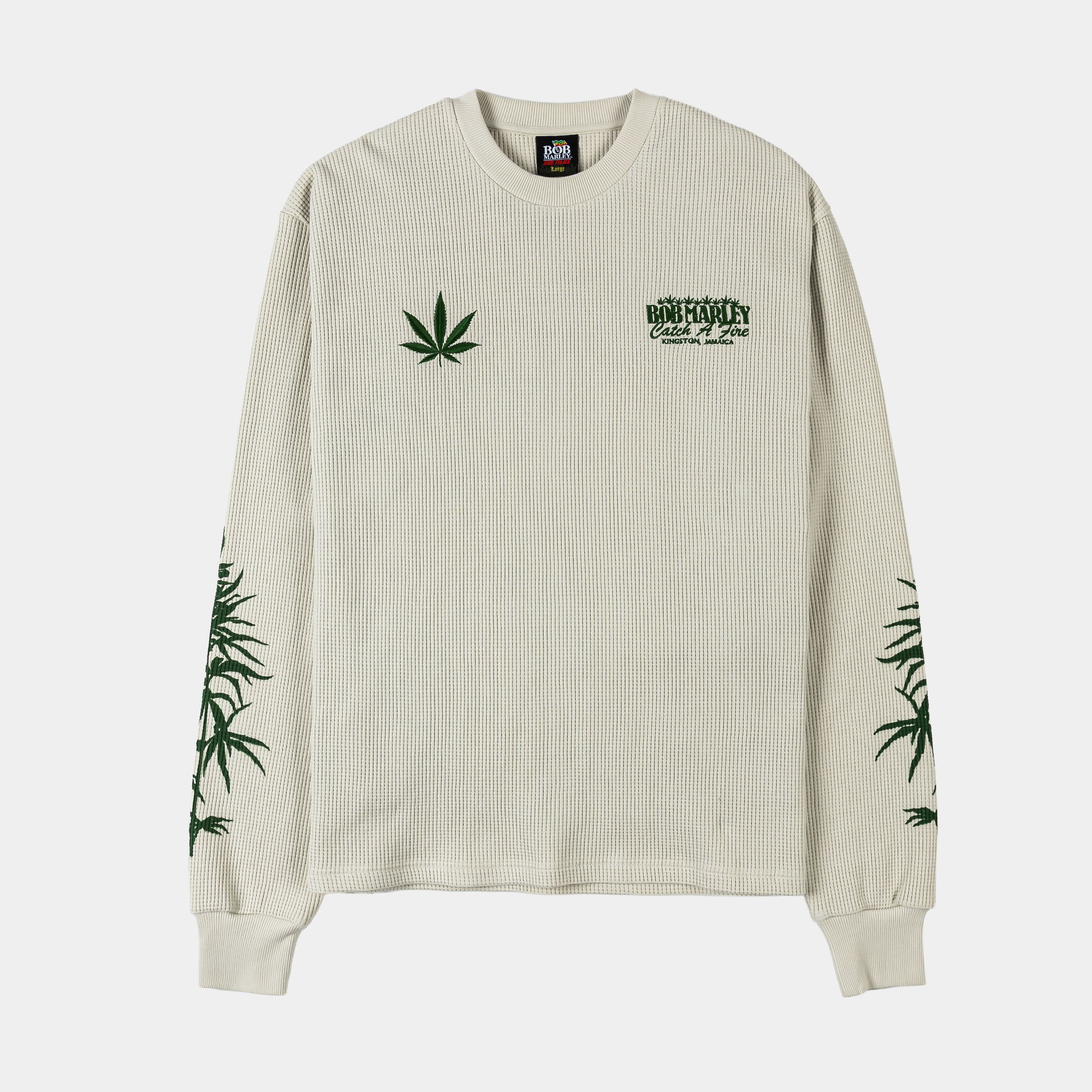 Long-sleeve shirt with green cannabis leaf designs on a light background.