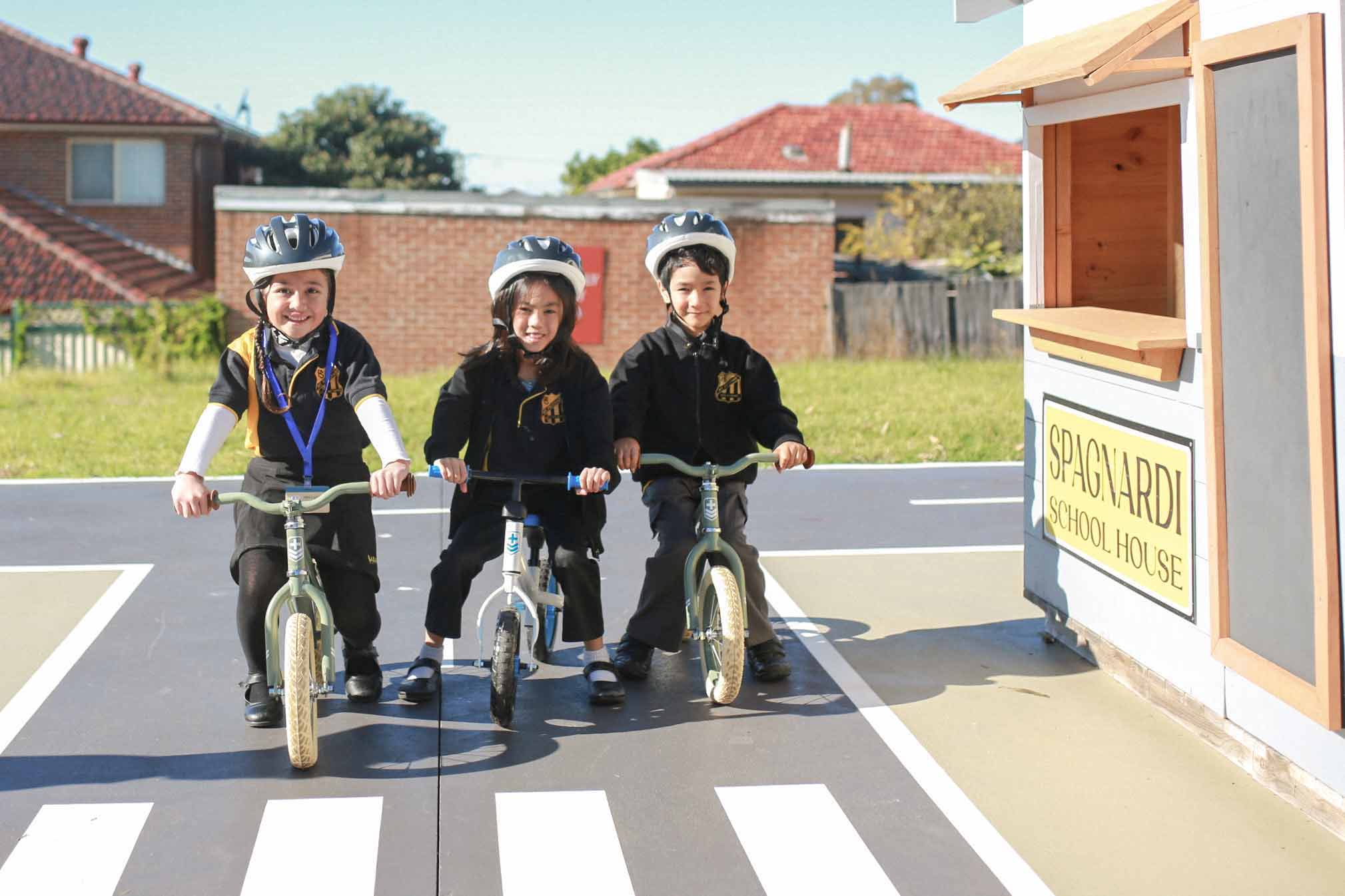 Kids riding their bikes in the Cubby House VIllage