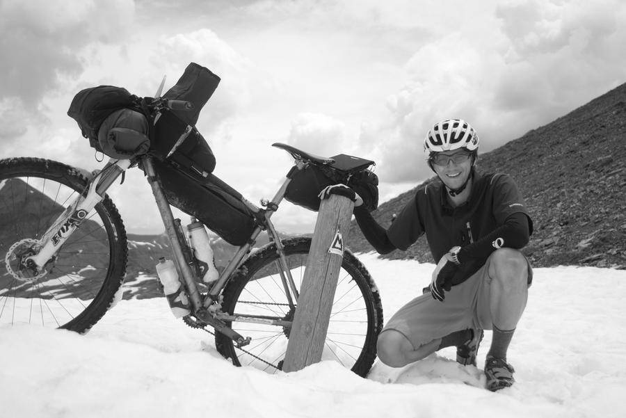 Hunt Marketing Manager, Samuel, smiling on a mountain with his bike