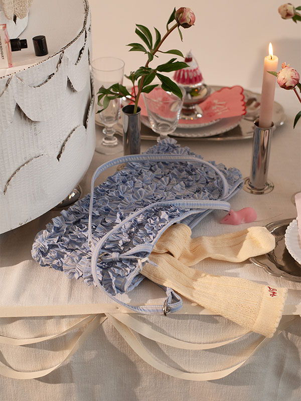 Dining table setting with flowers, napkins, and decorative items.