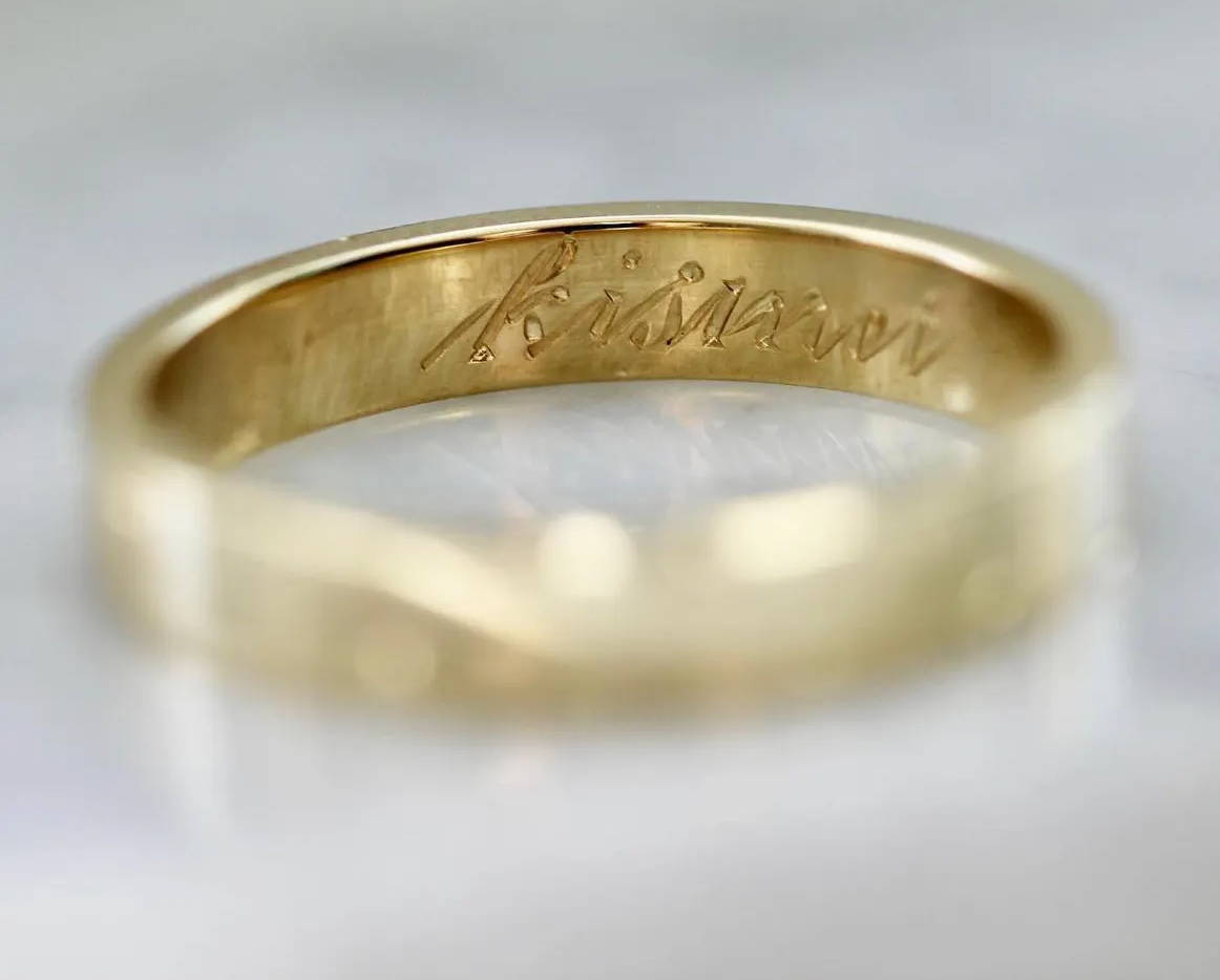 gold band with word engraved inside
