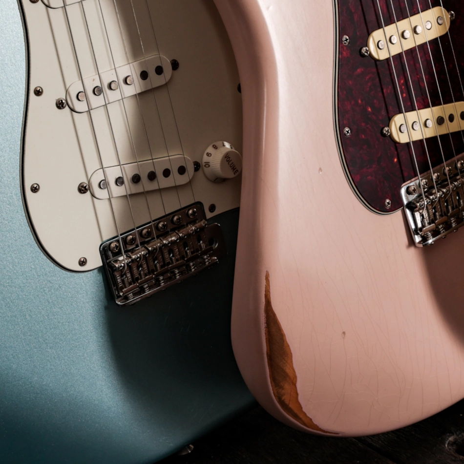 Close up photo of two Fender Road Worn Stratocaster guitars