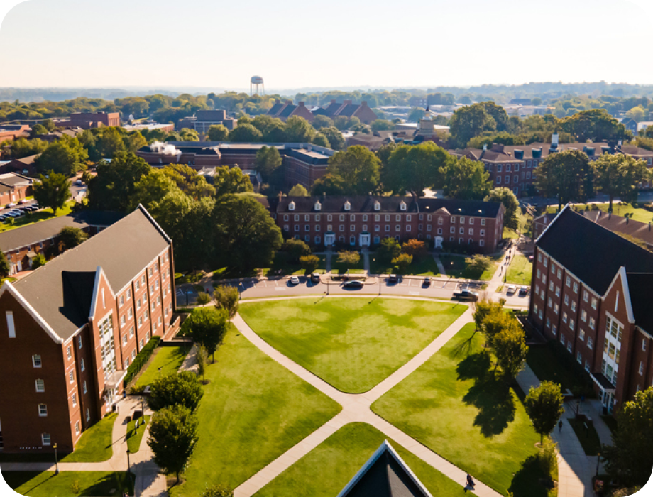 Aerial view of a college campus with buildings and green spaces.