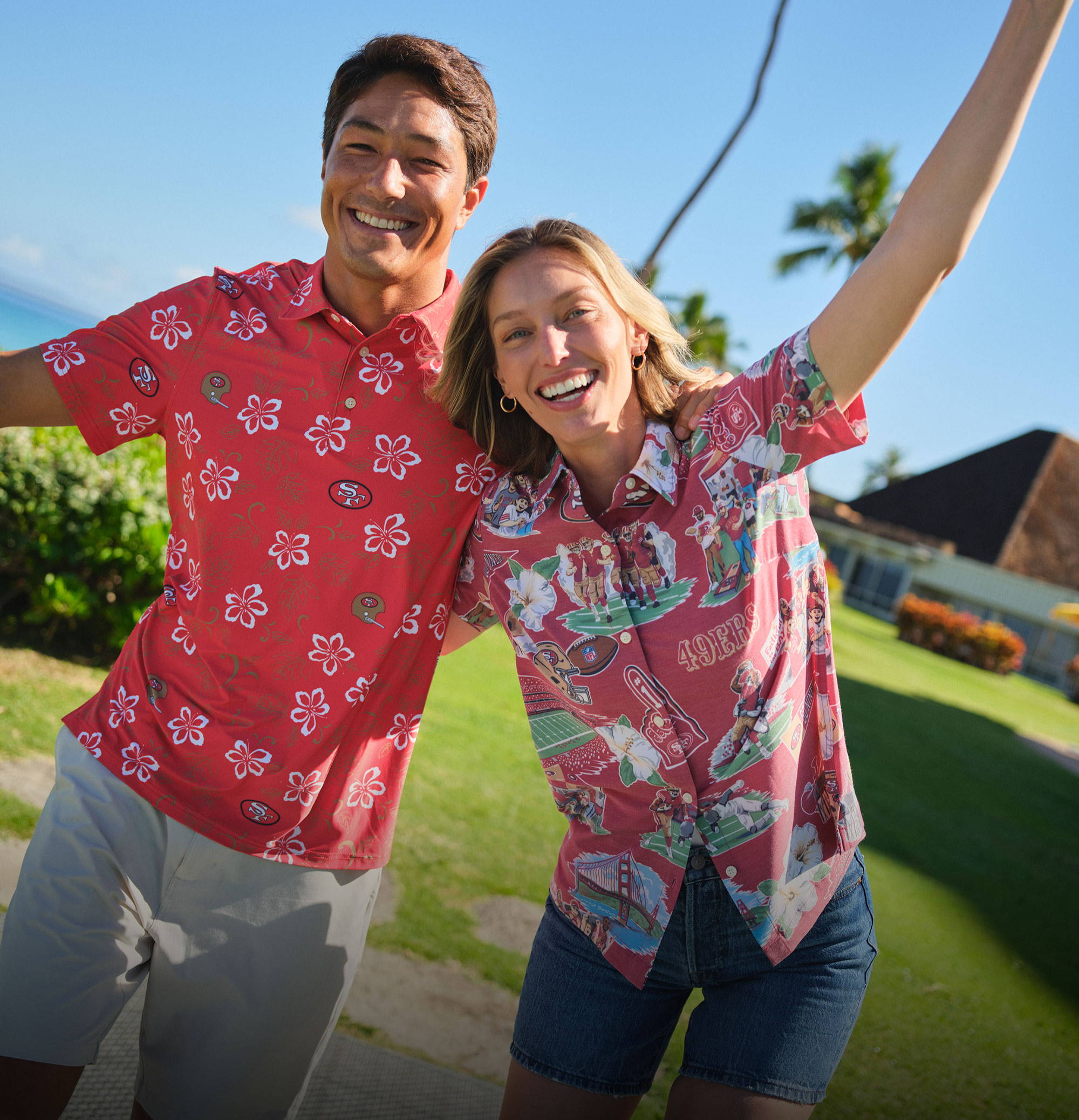 Two people in colorful shirts smiling and posing outdoors.