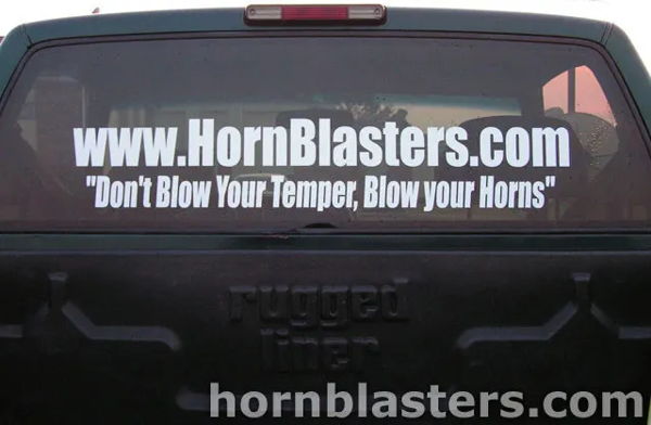 Rear tailgate view with HornBlasters decal on Winston's Silverado rear window photo 2