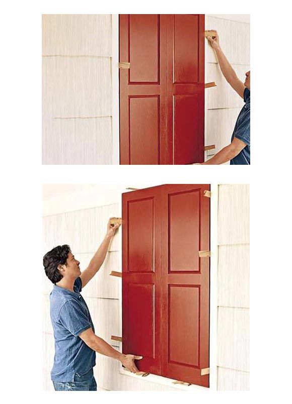 Person installing a red door on a wall, showing two stages of the process.