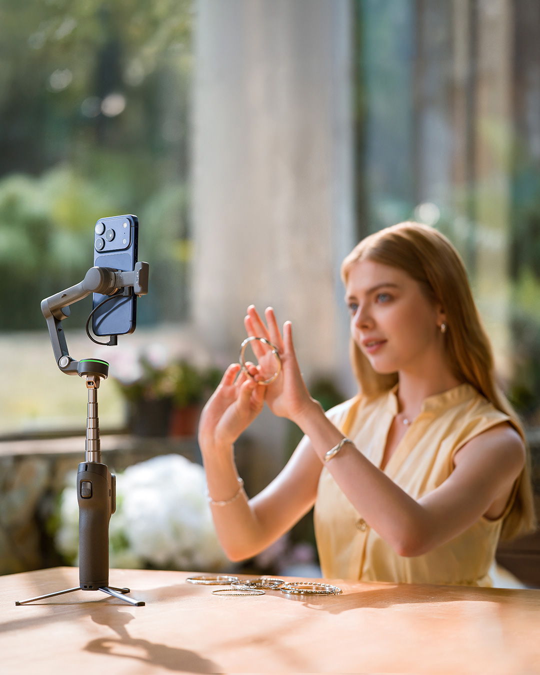 A person records with an Apple iPhone plugged into the Osmo Mobile 8P Multifunctional Module 2