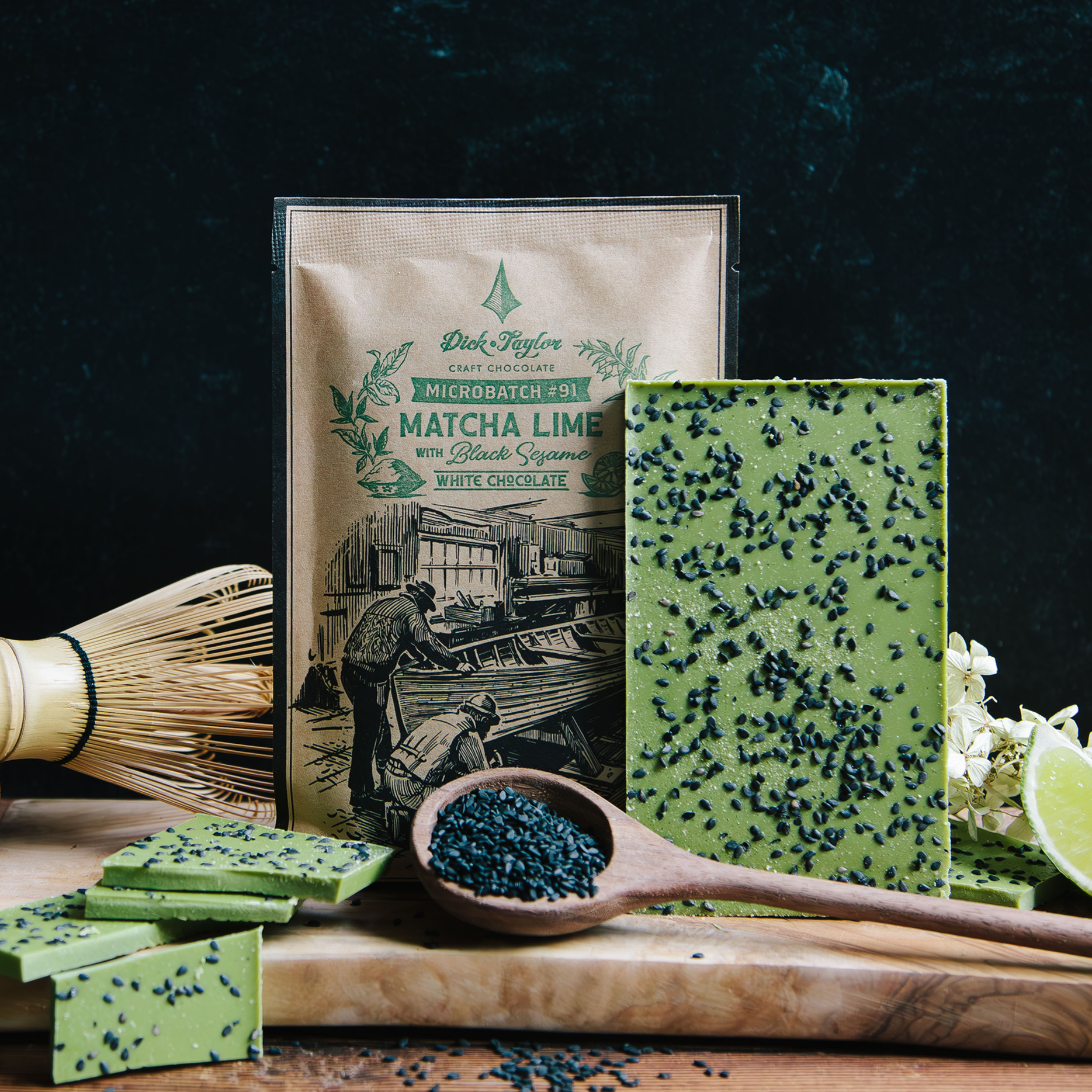 White chocolate made, green matcha with black sesame on the back next to kraft paper envelope