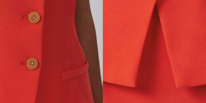 Close-up of a red jacket showing buttons and pocket details.