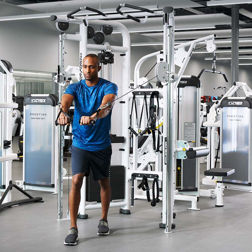 Male exercising on Signature Series Dual Adjustable Pulley cable machine in gym