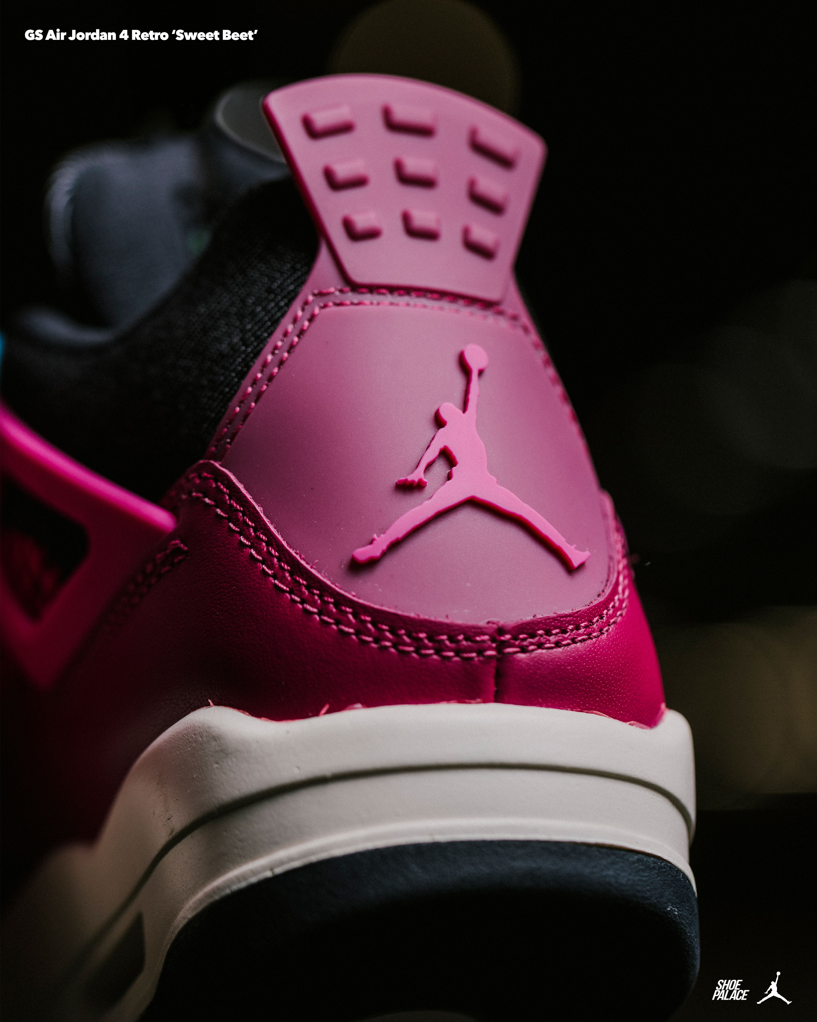 Close-up of a pink Air Jordan sneaker's heel with logo.