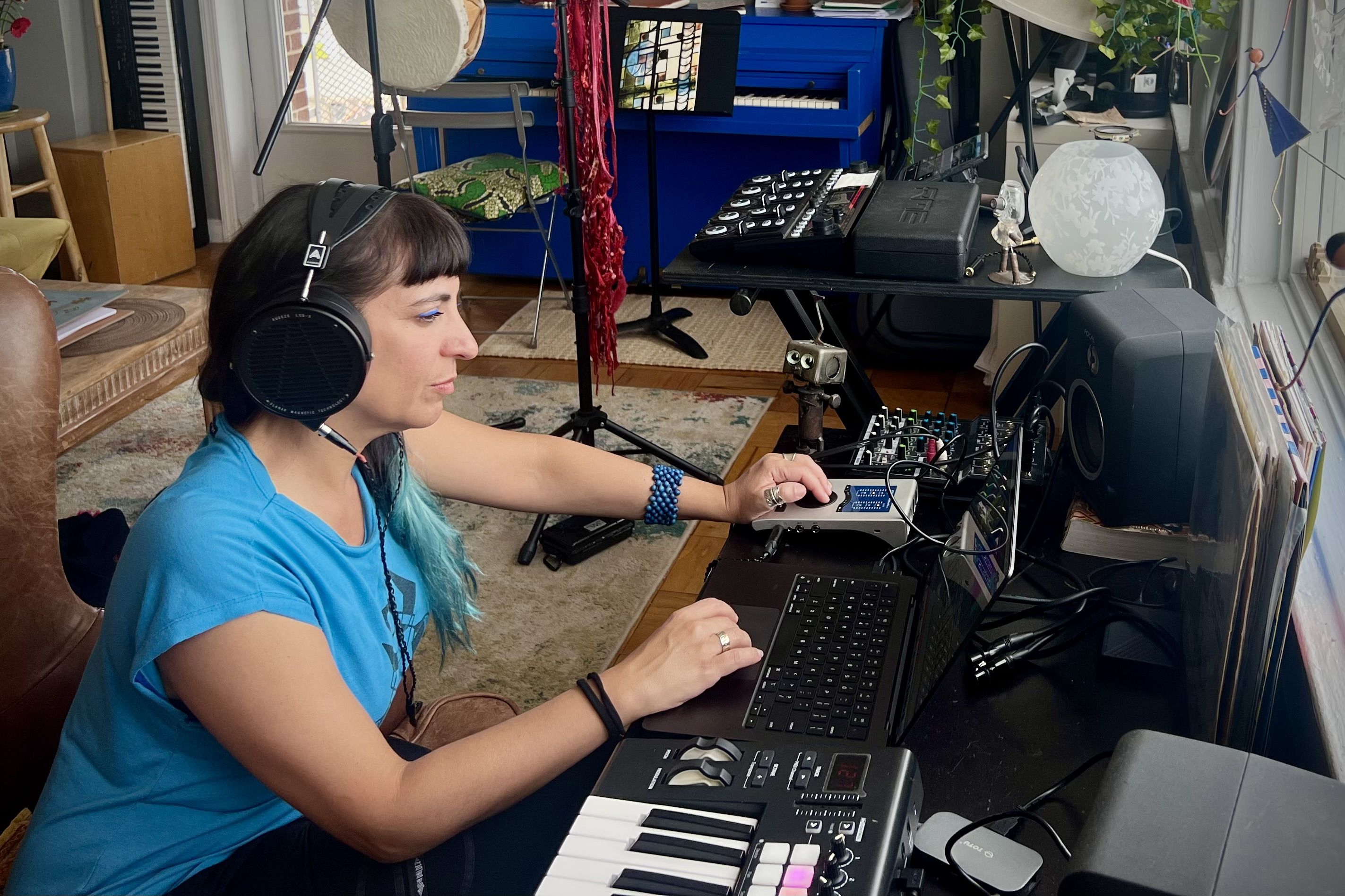 Sofía Rei wearing Audeze LCD-X headphones mixing in the studio 