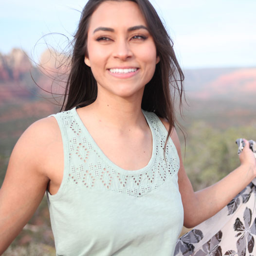 Woman standing over Sedona Arizona canyon wearing Seychelle tank top.