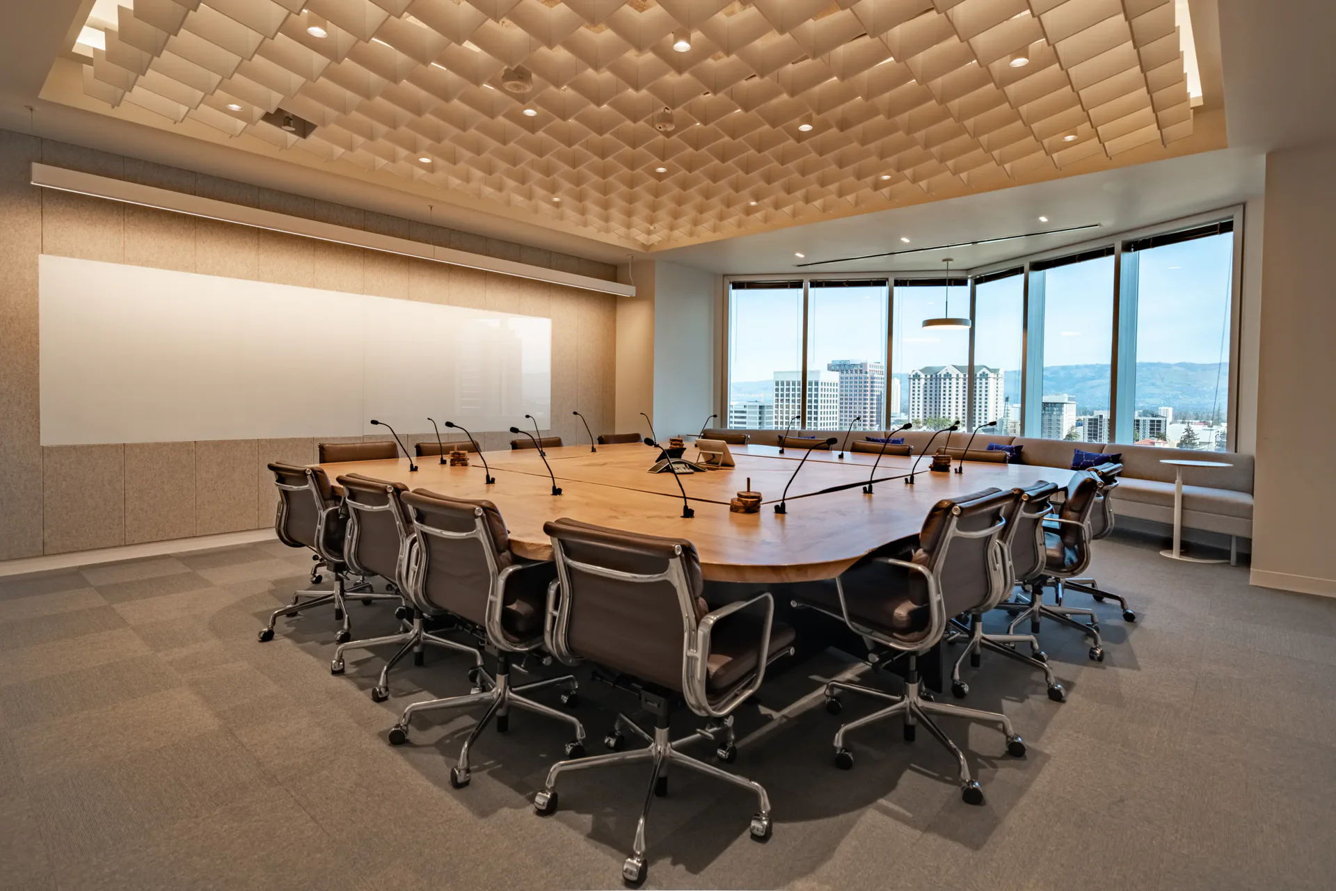 Modern conference room with a large table and panoramic city views.