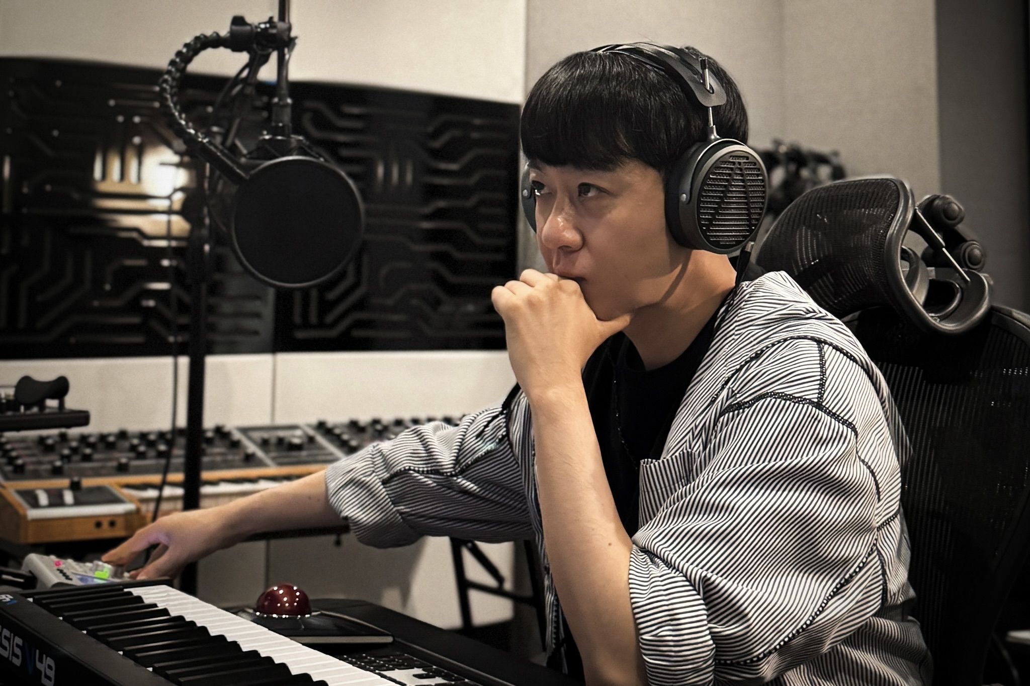 HwangHyun wearing Audeze MM-500 headphones in the studio