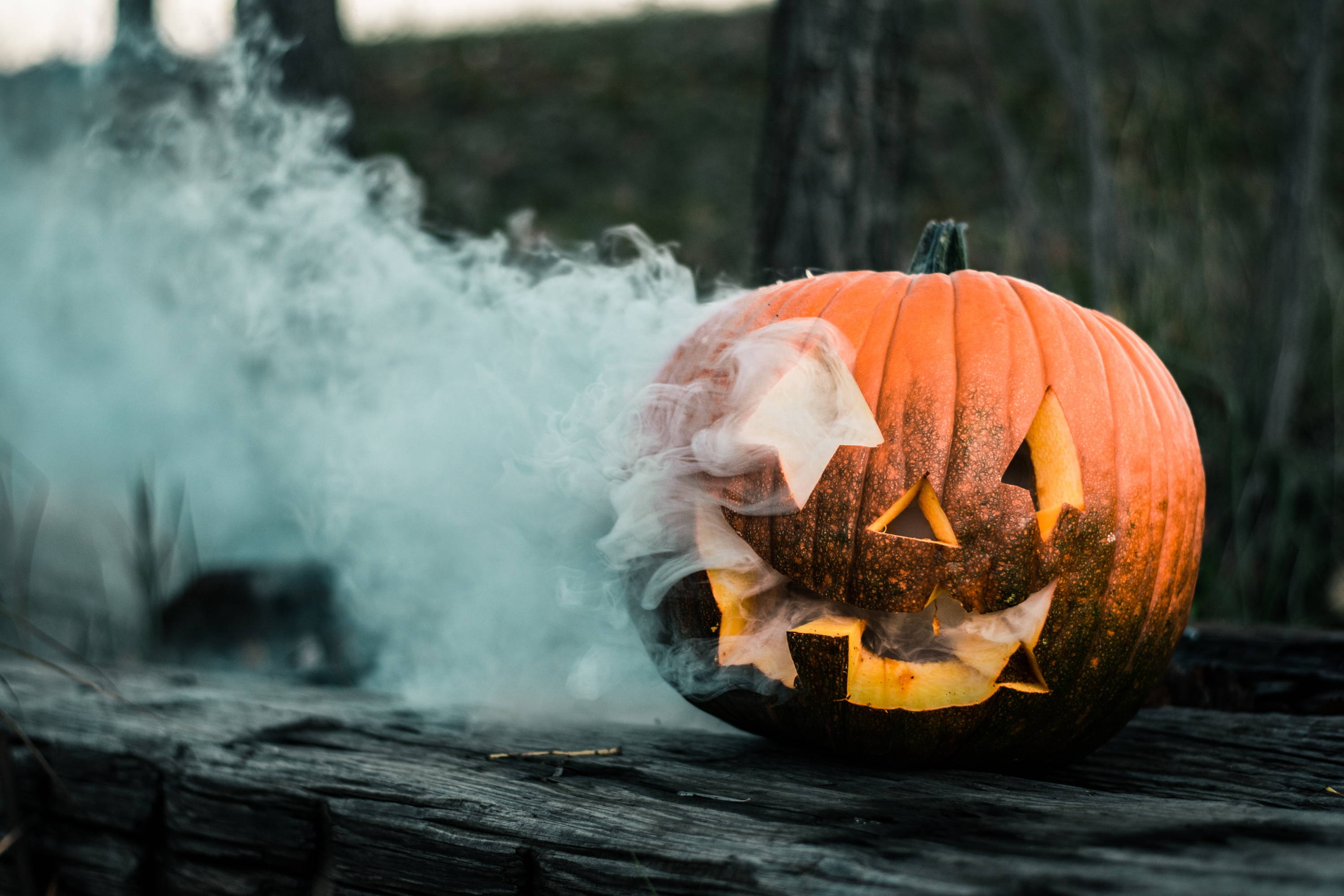 pumpkins in october with smoke on a wooden table, decorate