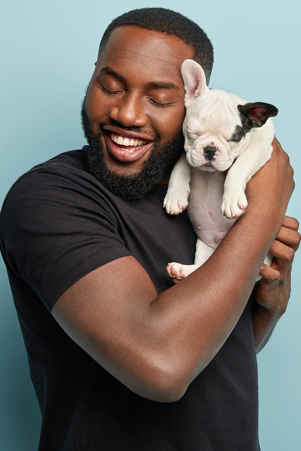 Man Hugging A Small Black And White Dog