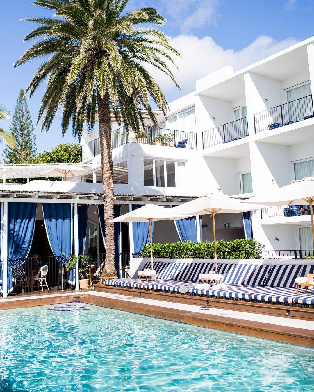 Halcyon House Exterior Pool Area Pergola White Wood Blue White Stripe Pool House Inspirational Design