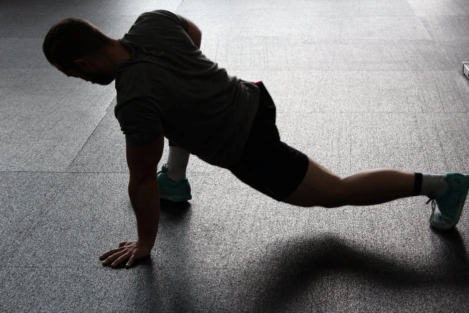 A man in training gear stretches before his workout.