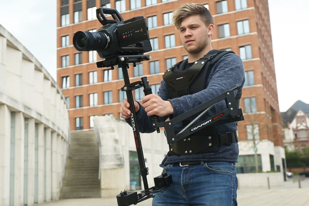 Operator filming with a stabilizer on the Flycam Comfort Arm and Vest