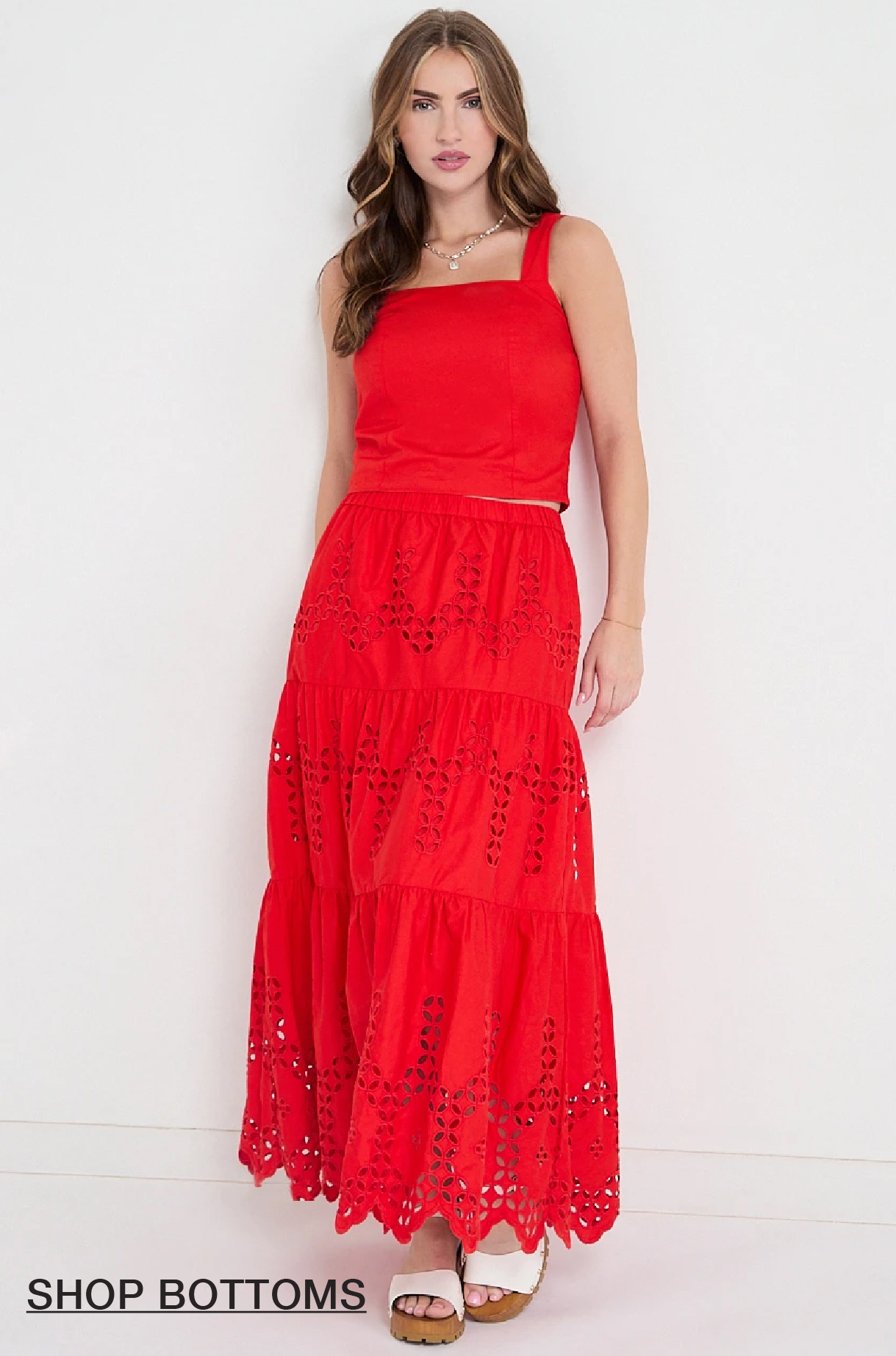 Woman in a red maxi dress with a layered design.