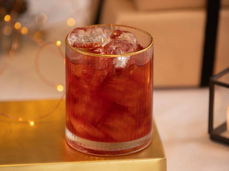 Winter Spiced Negroni in a gold rimmed cocktail glass on a gold tray
