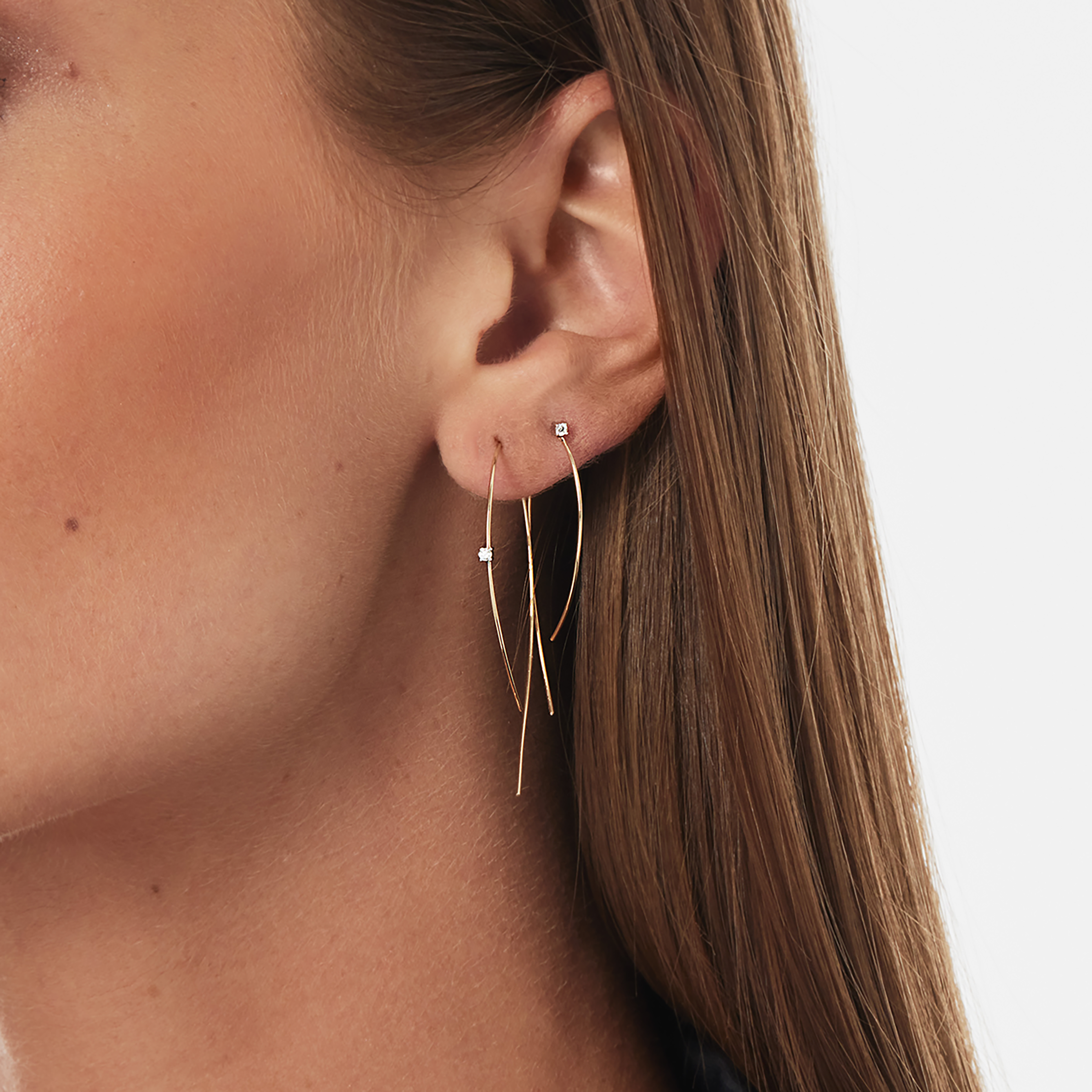 Gold hoop earrings with small diamond studs.
