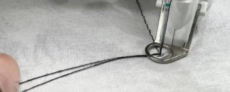 Holding down the needle thread loop
