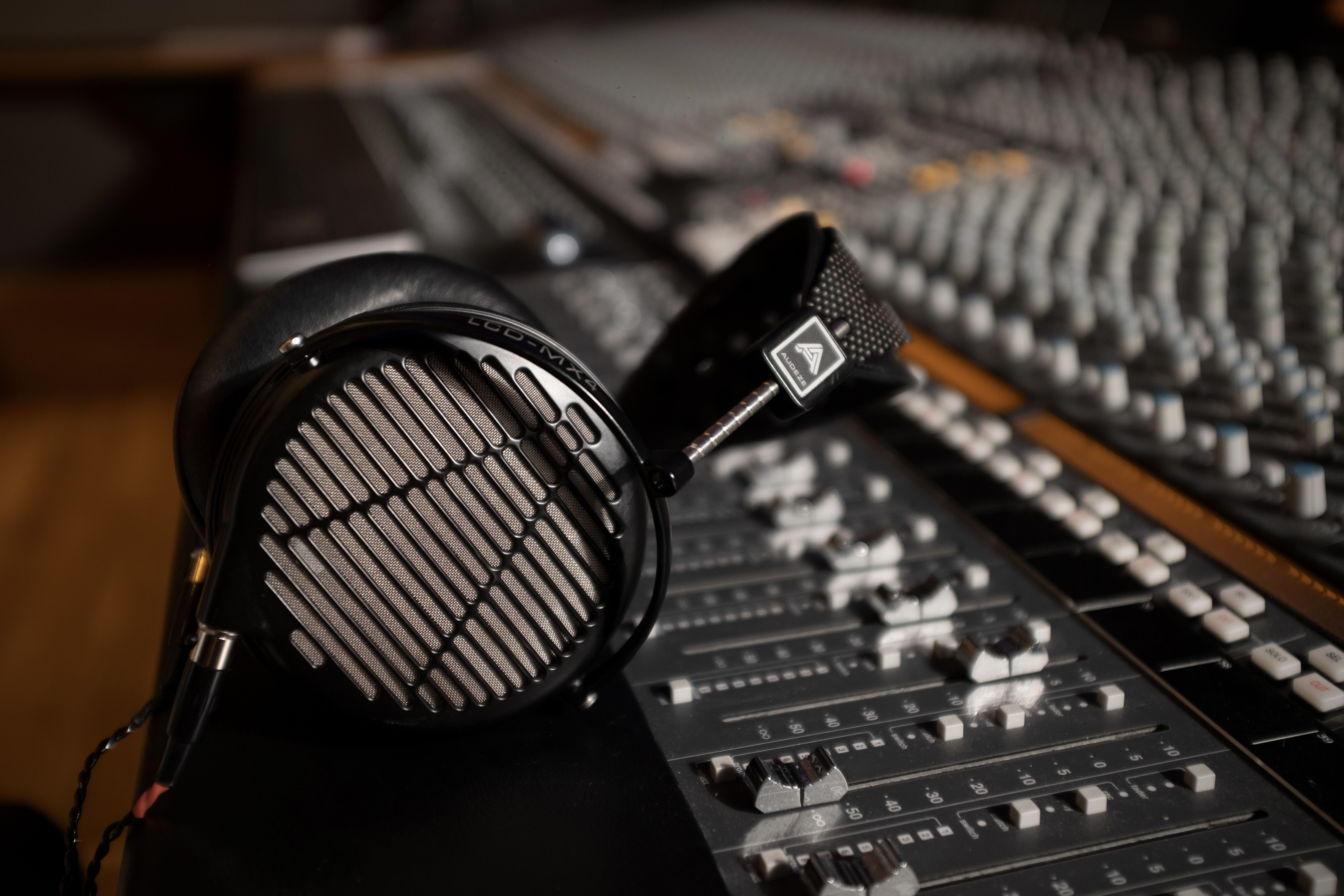 Audeze LCD-MX4 headphones laying on mixing console in the studio 