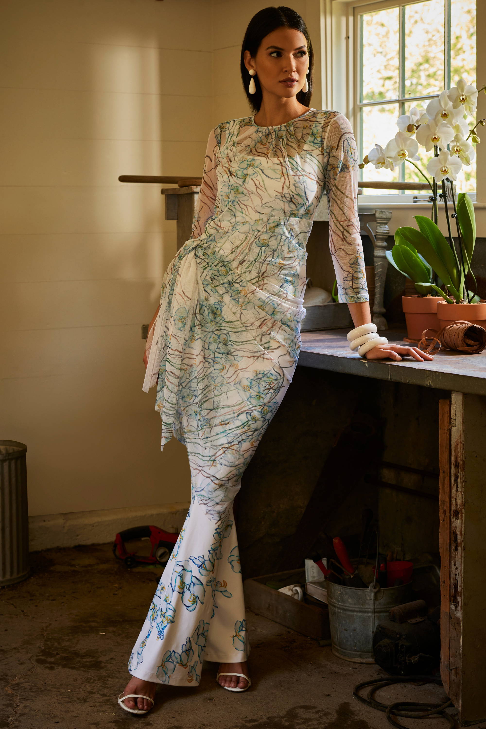 Woman wearing mesh topper over stretch knit floral tank top and pants by Ala von Auersperg for spring 2024