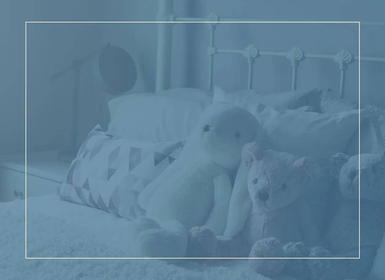 Cuddly bears and a rabbit on a child’s bed. Dust mites love bedrooms and can cause skin reactions if you’re allergic to them