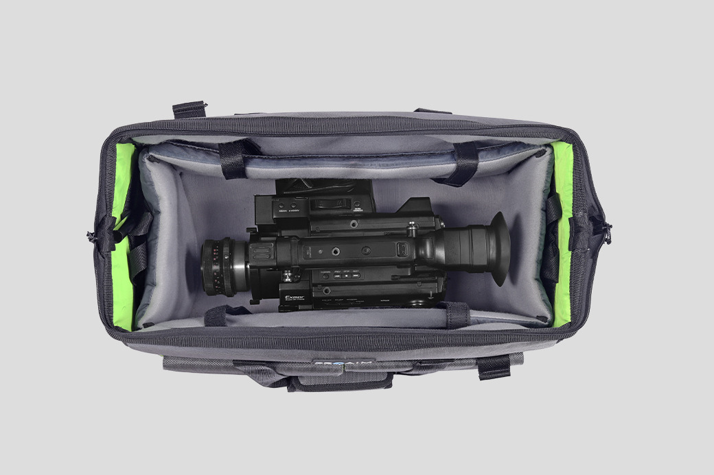 Camera equipment inside a gray bag with green accents.